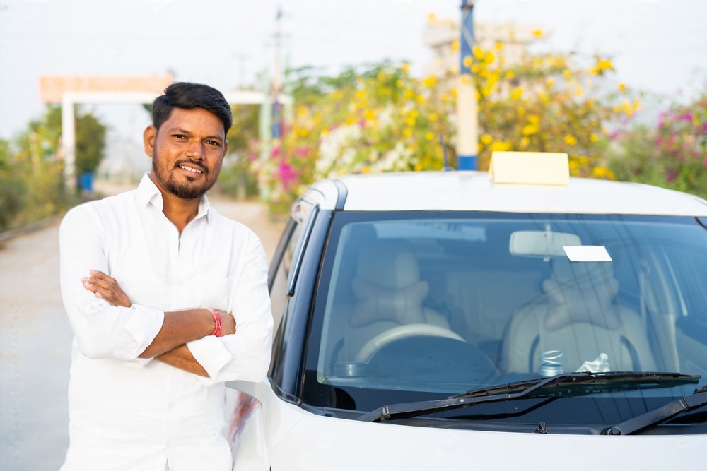 man standing in front of car